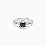 The 14K White Gold White and Black Diamond Halo Ring features a rectangular black center stone surrounded by white diamonds, with more diamonds along the band, all presented on a white background.