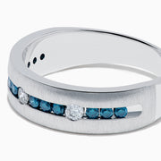 The Mens 14K White Gold Blue and White Diamond Band Ring features a row of blue and white diamonds, with four round white gemstones set into the band, shown on a plain white background.