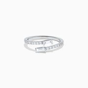 The 14K White Gold Diamond Bypass Ring features two rectangular baguette-cut diamonds at each end and a row of small round diamonds along the band, beautifully set against a white background.
