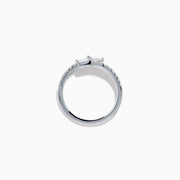 The 14K White Gold Diamond Bypass Ring features two rectangular baguette-cut diamonds at each end and a row of small round diamonds along the band, beautifully set against a white background.