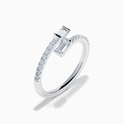 The 14K White Gold Diamond Bypass Ring features two rectangular baguette-cut diamonds at each end and a row of small round diamonds along the band, beautifully set against a white background.