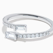 The 14K White Gold Diamond Bypass Ring features two rectangular baguette-cut diamonds at each end and a row of small round diamonds along the band, beautifully set against a white background.