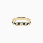 The Caviar 14K Yellow Gold Black and White Diamond Band Ring features alternating black and white diamonds in a channel setting, shown against a plain white background.