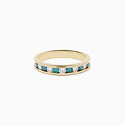 The Bella Bleu 14K Yellow Gold White and Blue Diamond Ring features alternating round blue and white diamonds in a single row, displayed on a plain white background.