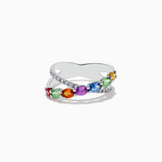 The Watercolors 14K White Gold Multi Sapphire and Diamond Crossover Ring features a crisscross design with vivid multicolored sapphires and a band set with sparkling diamonds, all showcased against a plain white background.
