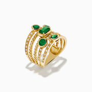 The 14K Yellow Gold Emerald and Diamond Statement Ring features five stacked bands, each adorned with emeralds and white accent stones in an intricate diamond design.