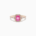 The 14K Rose Gold Pink Sapphire and Diamond Ring showcases a rectangular pink sapphire center, accented by white diamonds around the stone and along the band.