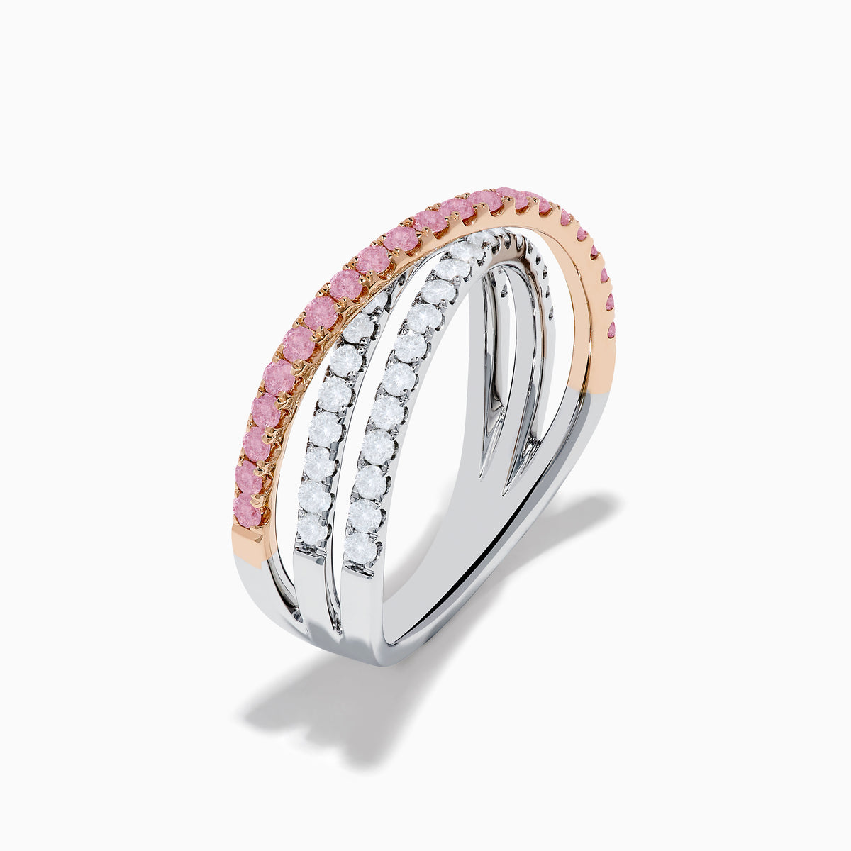 The 14K Two Tone Gold White and Pink Diamond Crossover Ring features three intersecting bands—two adorned with sparkling white and pink diamonds—shown on a white background.
