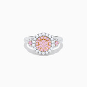 The 14K Two Tone Gold White and Pink Diamond Cluster Ring features a round cluster of pink diamonds at the center, encircled by white diamonds, with additional pink stones on each side for extra elegance.