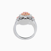 The 14K Two Tone Gold White and Pink Diamond Cluster Ring features a round cluster of pink diamonds at the center, encircled by white diamonds, with additional pink stones on each side for extra elegance.
