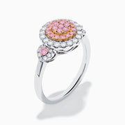 The 14K Two Tone Gold White and Pink Diamond Cluster Ring features a round cluster of pink diamonds at the center, encircled by white diamonds, with additional pink stones on each side for extra elegance.