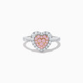 The Novelty 18K Two Tone Gold Pink and White Diamond Heart Ring showcases a heart-shaped center with pink and white diamonds, bordered by clear stones and accented with smaller stones along the band.