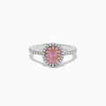 The 18K Two Tone Gold White and GIA Certified Pink Diamond Ring features a central oval pink diamond, double halo of pink and white stones, and additional white stones on the band for a stunning look.