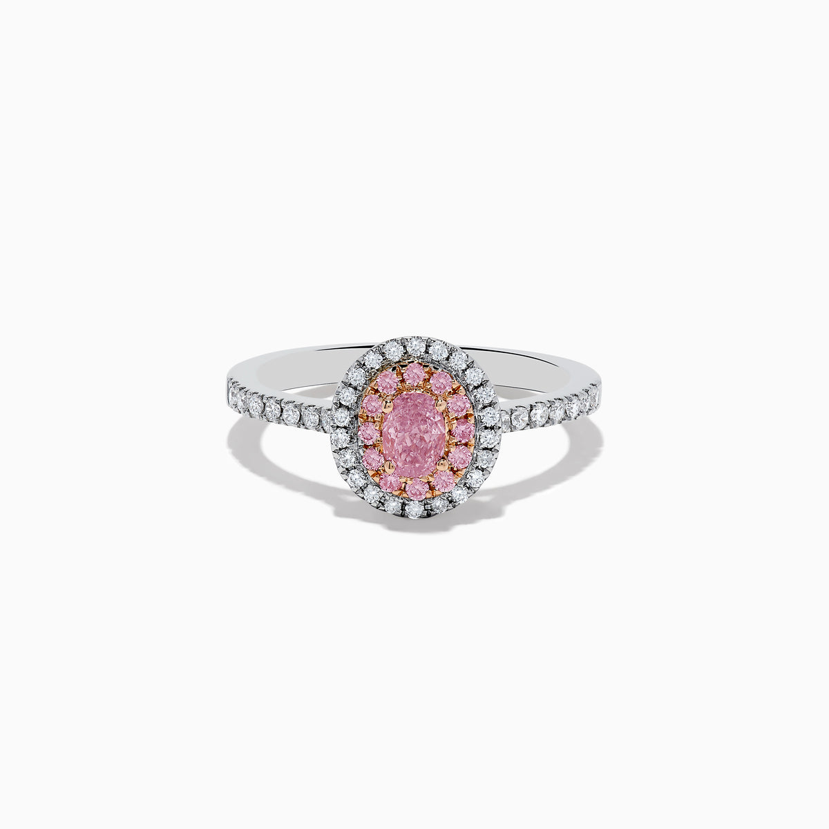 The 18K Two Tone Gold White and GIA Certified Pink Diamond Ring features a central oval pink diamond, double halo of pink and white stones, and additional white stones on the band for a stunning look.