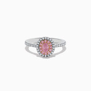 The 18K Two Tone Gold White and GIA Certified Pink Diamond Ring features a central oval pink diamond, double halo of pink and white stones, and additional white stones on the band for a stunning look.