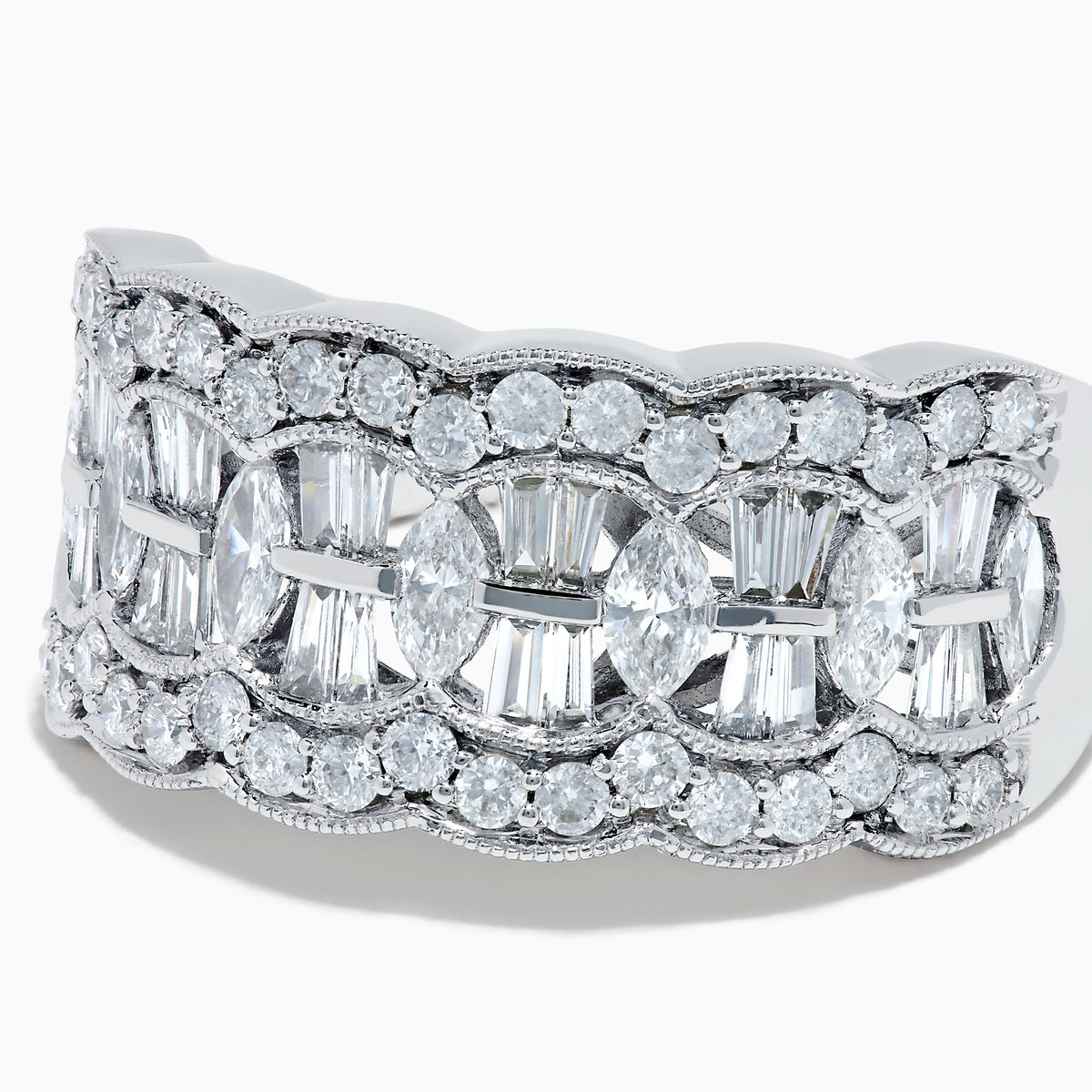 Experience timeless elegance with the 14K White Gold Diamond Multi Shape Wide Band Ring, showcasing two rows of brilliant round diamonds that border a central row of rectangular baguette-cut diamonds arranged in an intricate, repeating pattern.