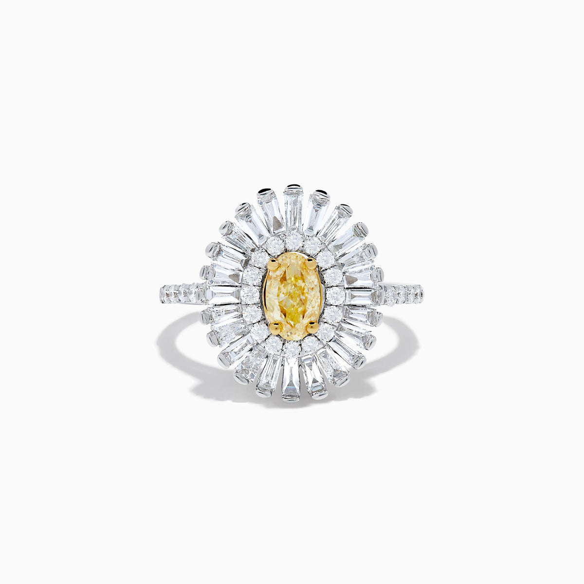 The Canare 18K Two Tone Gold Yellow and White Diamond Ring features an oval yellow centerpiece with a starburst halo of round and baguette white diamonds on a slim, diamond-studded band.
