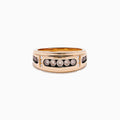 The Men's 14K Rose Gold Brown and White Diamond Ring showcases a row of seven round diamonds in a rose gold and black band, accented by smaller diamonds on each side, set against a white background.