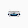 Men’s 14K White Gold Channel Set Blue and White Diamond Band featuring a row of round blue and white diamonds at the center, flanked by smaller white gems on each side, displayed on a white background.
