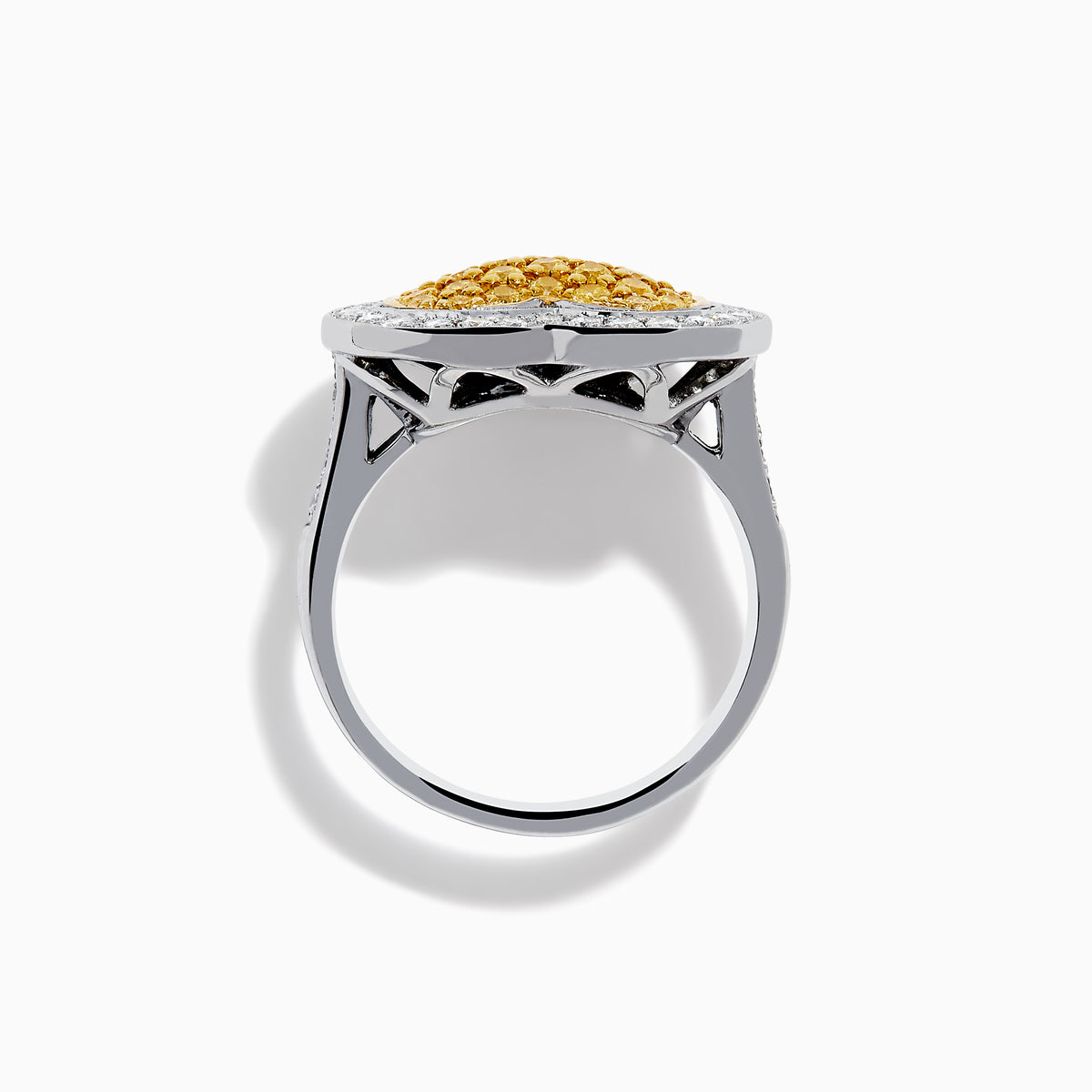 The Canare 18K Two Tone Gold Yellow Diamond Heart Ring, featuring a yellow diamond center with clear white stones on a silver band, is displayed against a white background.