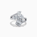The Classique 14K White Gold Diamond Crossover Ring features an elegant, twisting band set with round and baguette-cut diamonds, shown against a white background.