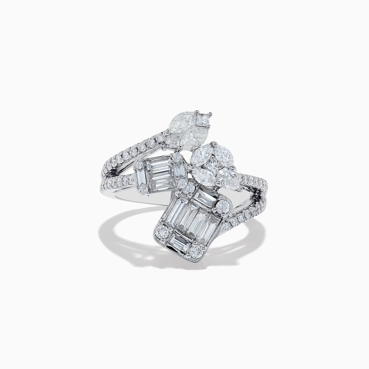 The Classique 14K White Gold Diamond Crossover Ring features an elegant, twisting band set with round and baguette-cut diamonds, shown against a white background.
