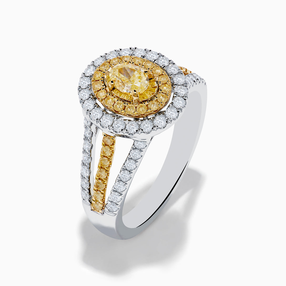 A close-up of the Canare 18K Two Tone Gold White and Yellow Diamond Ring, showcasing a yellow center stone in a halo of yellow and white diamonds on a split band with additional white and yellow diamonds.