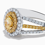 A close-up of the Canare 18K Two Tone Gold White and Yellow Diamond Ring, showcasing a yellow center stone in a halo of yellow and white diamonds on a split band with additional white and yellow diamonds.