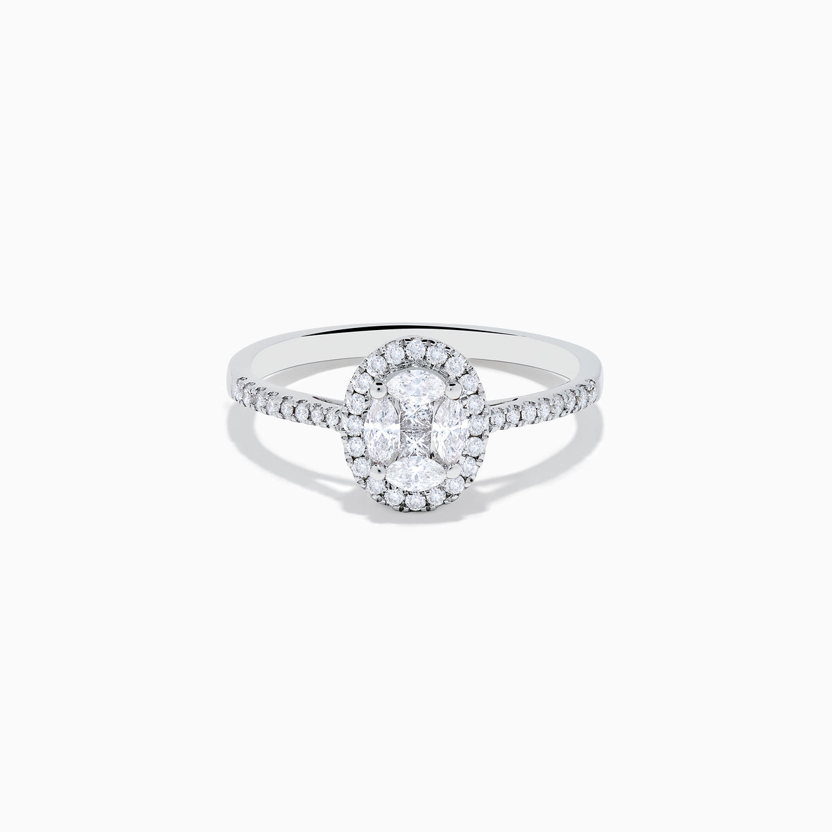 The Classique 14K White Gold Diamond Cluster Ring features an oval center diamond haloed by smaller diamonds, plus additional diamonds along its elegant band.