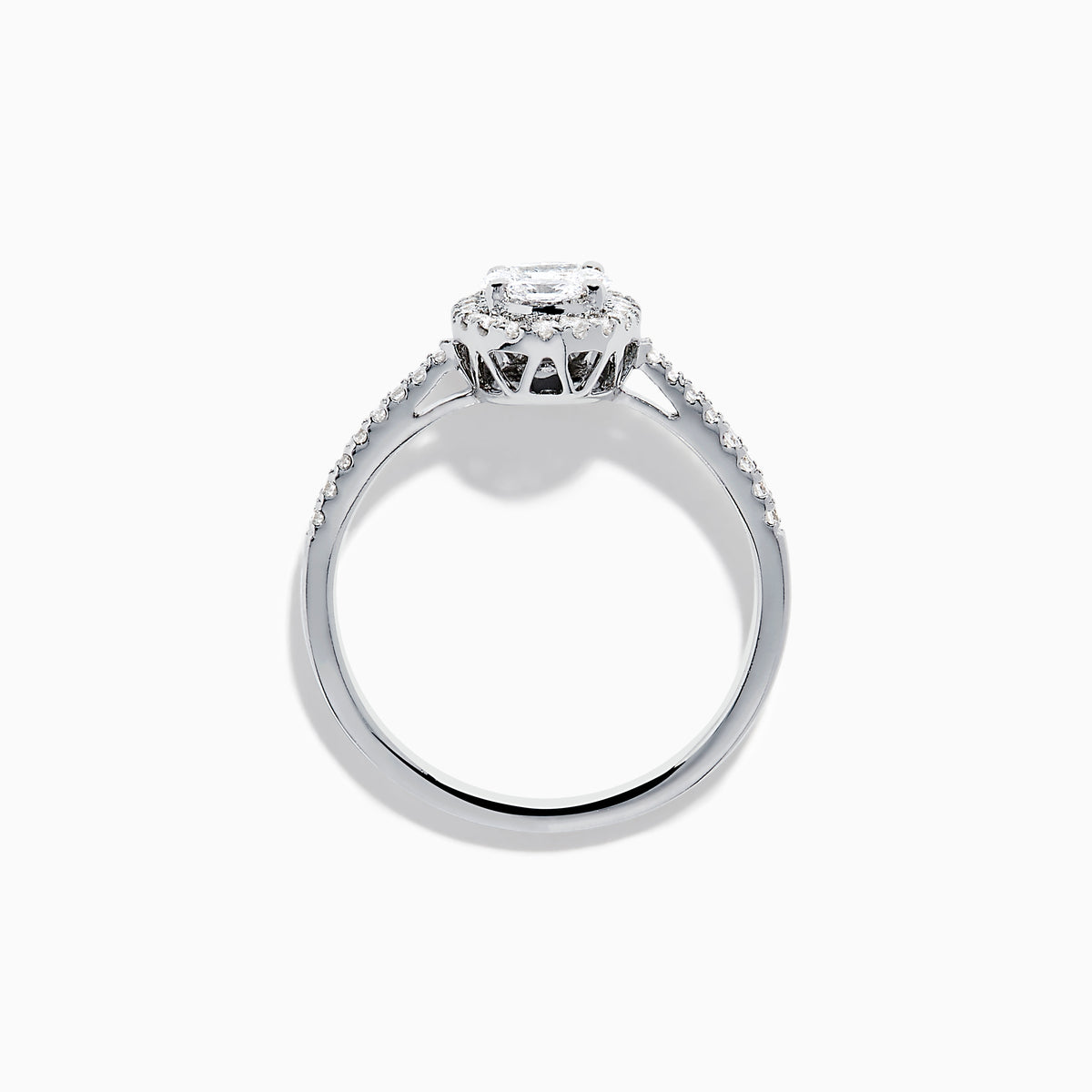 The Classique 14K White Gold Diamond Cluster Ring features an oval center diamond haloed by smaller diamonds, plus additional diamonds along its elegant band.