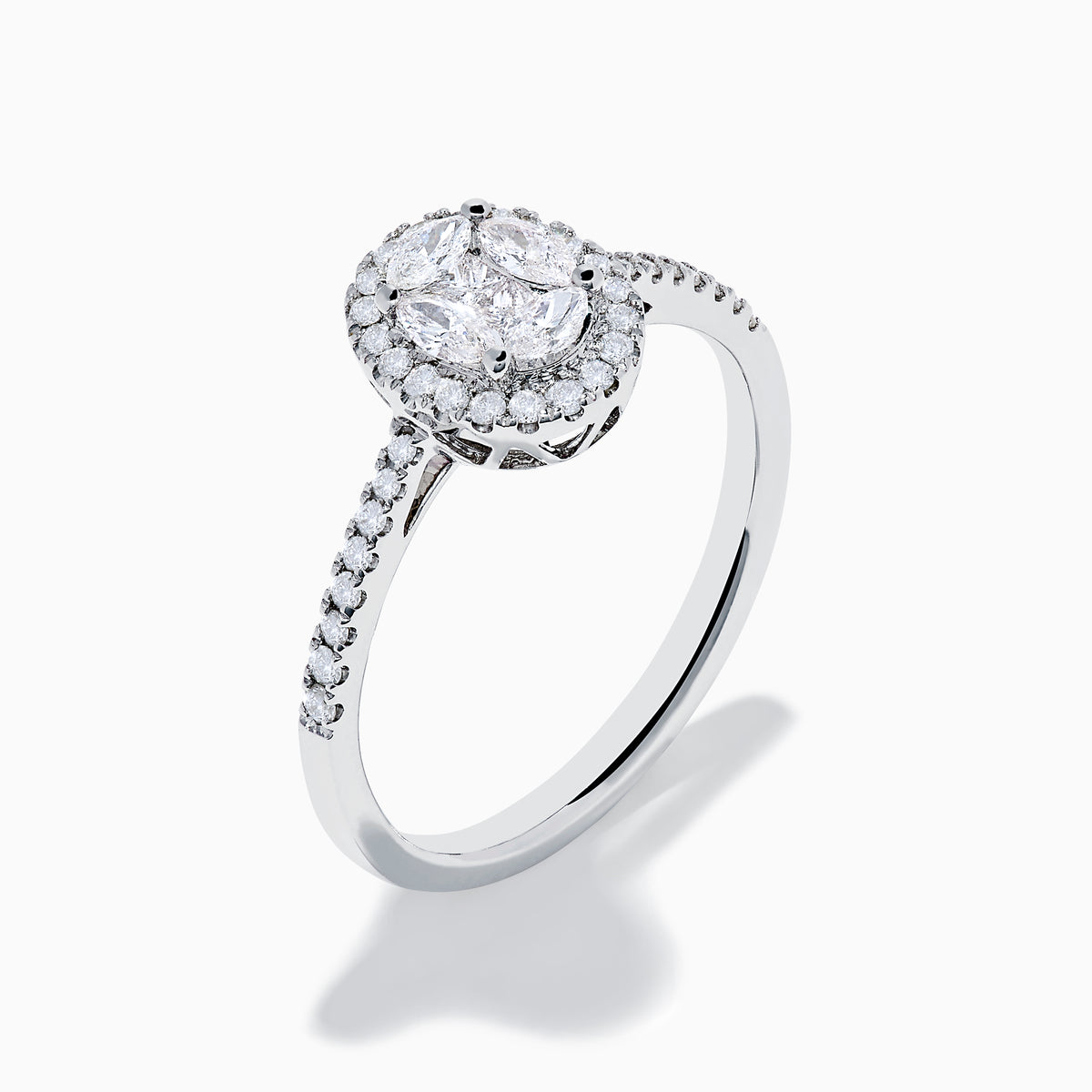 The Classique 14K White Gold Diamond Cluster Ring features an oval center diamond haloed by smaller diamonds, plus additional diamonds along its elegant band.