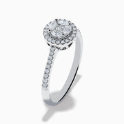 The Bouquet 14K White Gold Diamond Cluster Ring features an oval center diamond with a halo of smaller diamonds and a diamond-studded band, beautifully displayed against a plain white background.