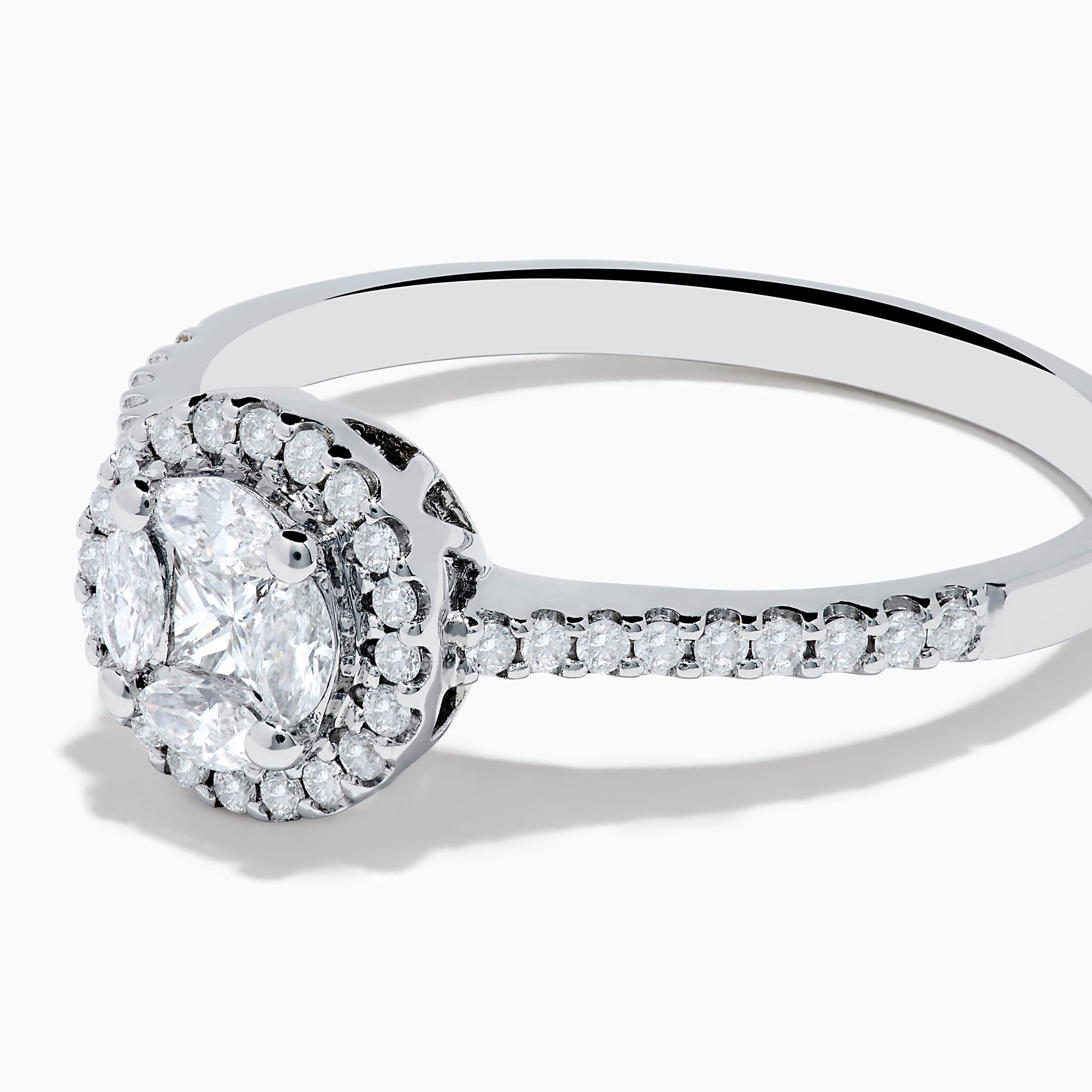 The Bouquet 14K White Gold Diamond Cluster Ring features an oval center diamond with a halo of smaller diamonds and a diamond-studded band, beautifully displayed against a plain white background.