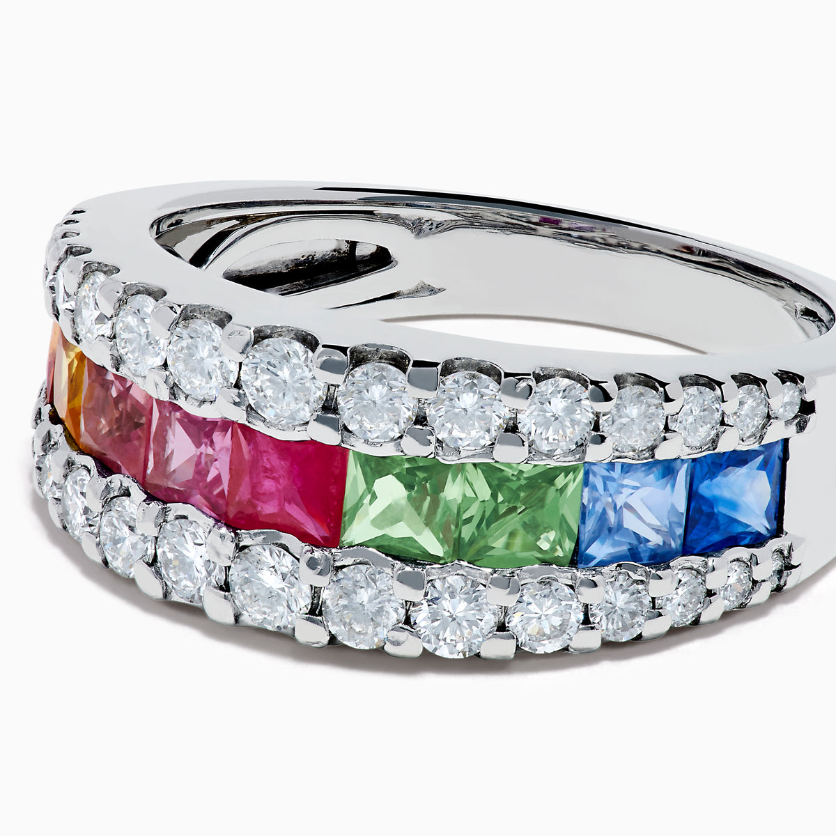 The Watercolors 14K White Gold Channel Set Multi Sapphire and Diamond Band showcases vibrant square-cut sapphires in a rainbow of colors, framed by sparkling round diamonds for a dazzling, colorful statement piece.
