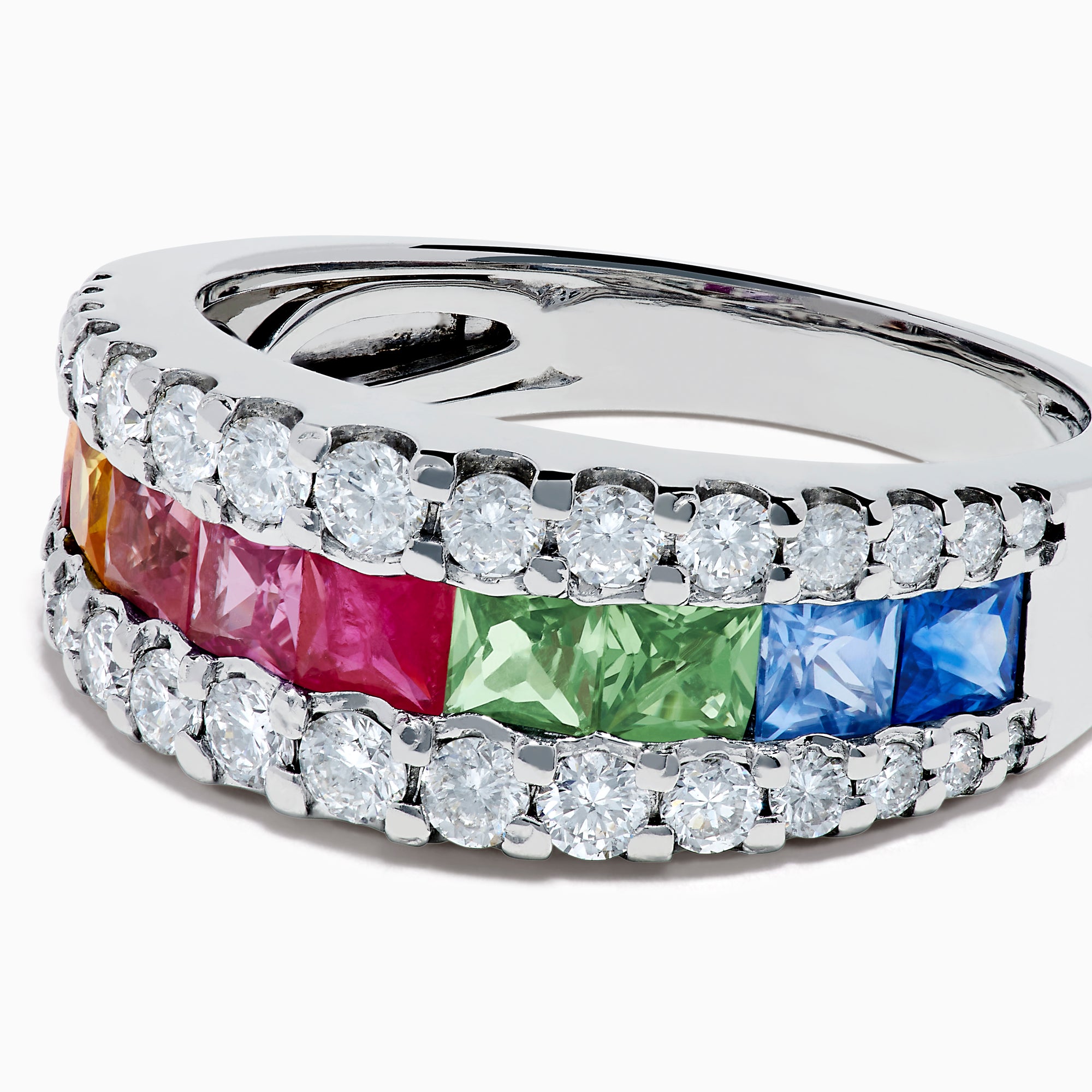 The Watercolors 14K White Gold Channel Set Multi Sapphire and Diamond Band showcases vibrant square-cut sapphires in a rainbow of colors, framed by sparkling round diamonds for a dazzling, colorful statement piece.