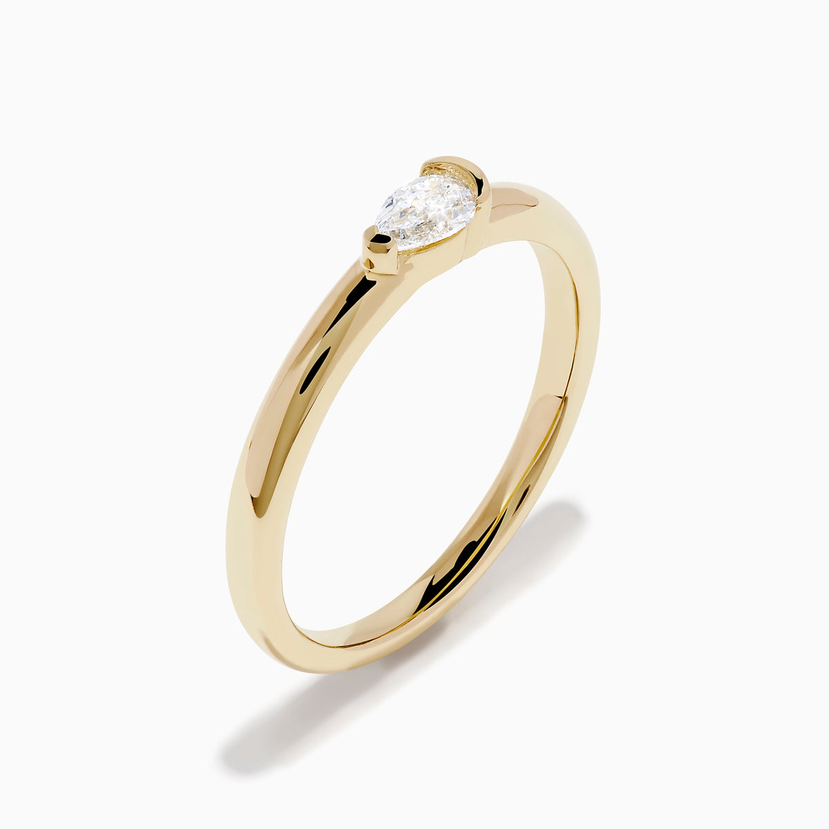 The D'Oro 14K Yellow Gold Diamond Ring showcases a single round-cut diamond solitaire in a minimalist prong setting, presented on a white background.