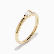 The D'Oro 14K Yellow Gold Diamond Ring showcases a single round-cut diamond solitaire in a minimalist prong setting, presented on a white background.