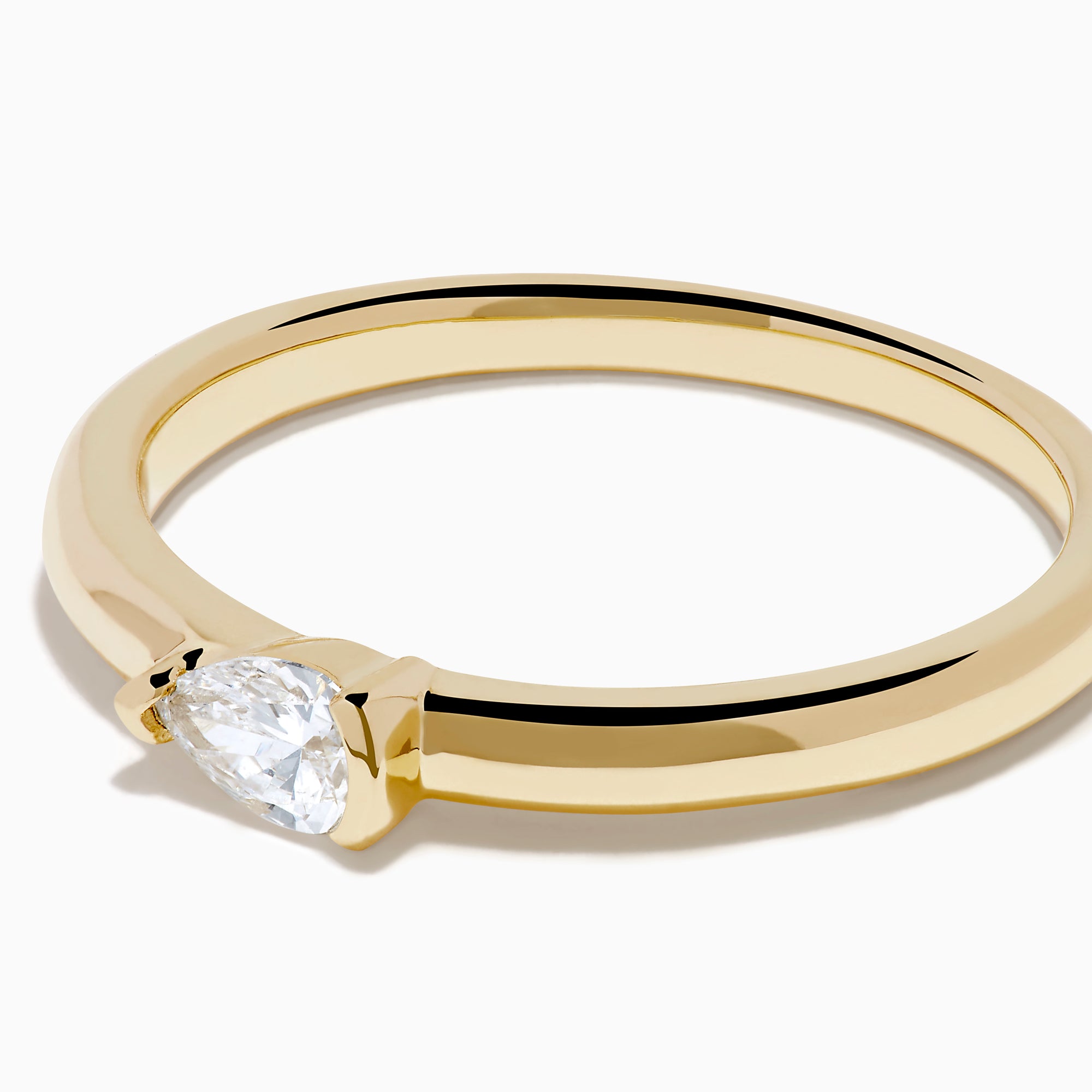 The D'Oro 14K Yellow Gold Diamond Ring showcases a single round-cut diamond solitaire in a minimalist prong setting, presented on a white background.