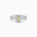 The Canare 18K Two-Tone Gold Marquise Shaped Yellow Diamond Ring showcases a vivid marquise-cut yellow diamond center, accented by a white diamond halo and additional diamonds along its elegant split shank band.