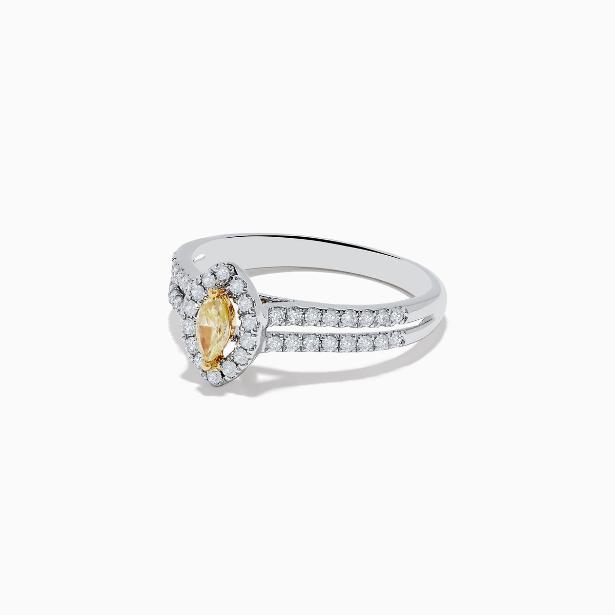 The Canare 18K Two-Tone Gold Marquise Shaped Yellow Diamond Ring showcases a vivid marquise-cut yellow diamond center, accented by a white diamond halo and additional diamonds along its elegant split shank band.
