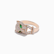 The Signature 14K Rose Gold Emerald and Diamond Panther Ring features a panther’s head with diamond accents, emerald-green gemstone eyes, and two curved diamond-studded bands held in its mouth.