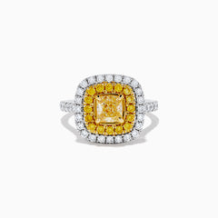 The Canare 14k Two Tone Gold Cushion Cut Double Halo Yellow Diamond Ring (1.86 TCW) features a vibrant yellow diamond centerpiece, framed by a double halo of yellow and white diamonds on a sleek two-tone band.