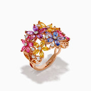 The Watercolors 14K Rose Gold Multi Sapphire and Diamond Flowers Ring showcases floral designs with blue, pink, yellow, and purple sapphires as petals, accented by small diamonds, set against a white background.
