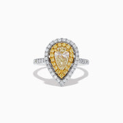The Canare 14K Two-Tone Pear Shaped Double Halo Yellow Diamond Ring showcases a central clear diamond, haloed by yellow stones and white diamonds, set on a two-tone band accented with sparkling white diamonds.