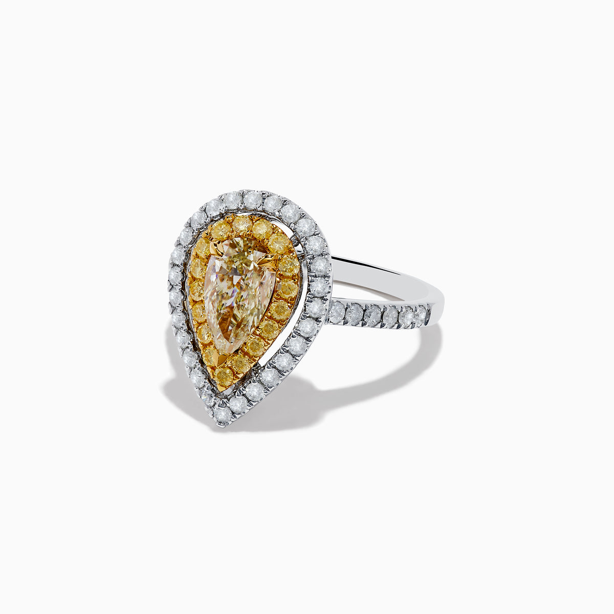 The Canare 14K Two-Tone Pear Shaped Double Halo Yellow Diamond Ring showcases a central clear diamond, haloed by yellow stones and white diamonds, set on a two-tone band accented with sparkling white diamonds.