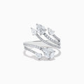 The Pave Classica 14k White Gold Open Shank Diamond Ring 1.0 TCW features four curved bands adorned with small and pear-shaped diamonds, elegantly set in white gold.