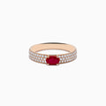 The Ruby Royale 14K Rose Gold Ruby and Diamond Ring features an oval ruby center stone with rows of round white diamonds along the band, beautifully showcased on a white background.