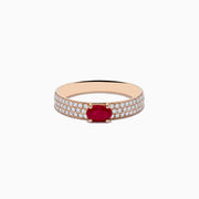 The Ruby Royale 14K Rose Gold Ruby and Diamond Ring features an oval ruby center stone with rows of round white diamonds along the band, beautifully showcased on a white background.