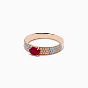 The Ruby Royale 14K Rose Gold Ruby and Diamond Ring features an oval ruby center stone with rows of round white diamonds along the band, beautifully showcased on a white background.