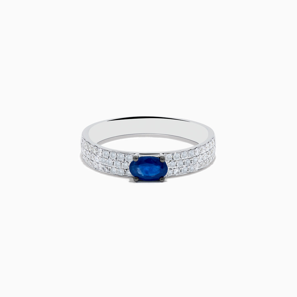 The Royal Bleu 14K White Gold Sapphire and Diamond Ring showcases an oval blue sapphire centerpiece with rows of small diamonds along the band, all set against a plain white background.